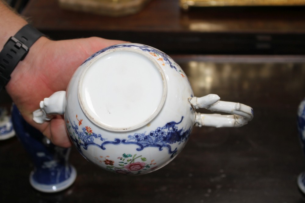 An 18th century Chinese export teapot and a pair of prunus pattern vases and covers